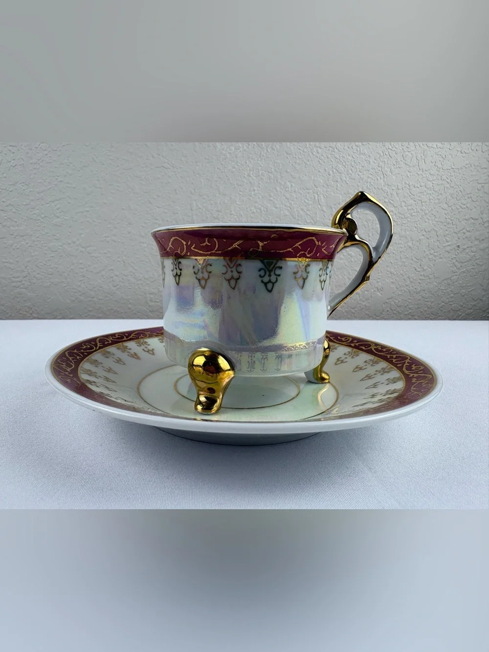 Vintage Porcelain Three-Legged Teacup and Saucer.